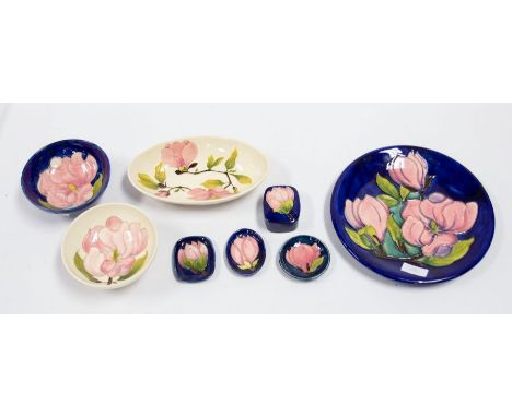 Moorcroft plate, bowl, dishes, trinket box with cover, and in dishes all in Magnolia pattern, 2 in white rest in blue. (8 ite