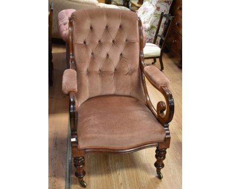 A Victorian gentleman's mahogany button back open salon armchair, down-swept scrolling arms with padded elbow supports,&nbsp;