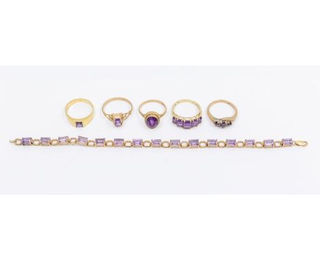 A collection of amethyst set gold rings to include a yellow metal ring set with a square cut amethyst size N, unmarked possib