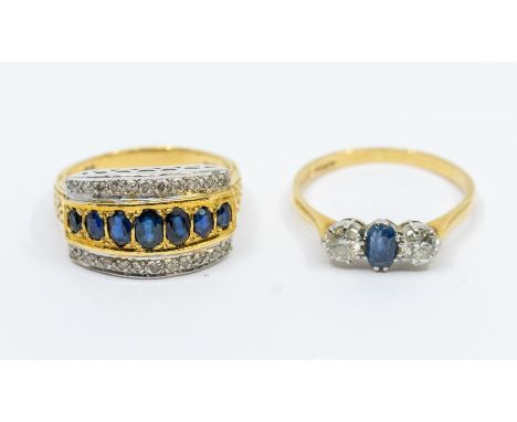 A sapphire and diamond three stone 18ct gold ring, comprising an oval sapphire to the centre approx 3 x 5mm, set either side 