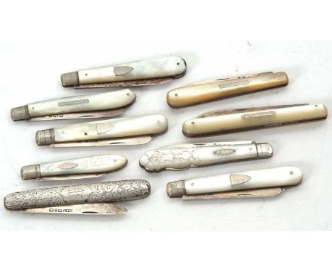 A group of eight mother of pearl handle fruit folding knives with hallmarked silver blades, various dates and makers together