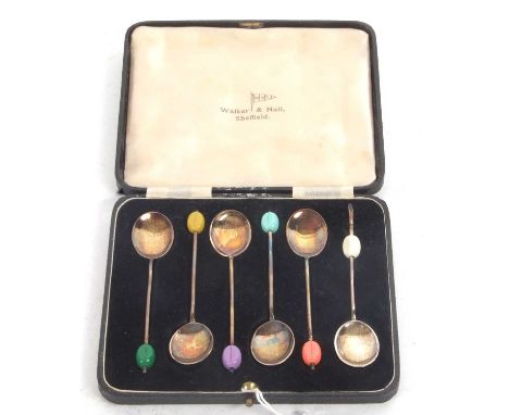 Cased set of six silver gilt and enamel bean end coffee spoons, the different coloured finials matching to the verso enamel b