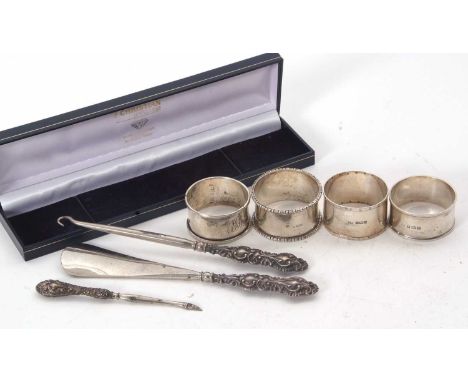 Mixed Lot:  Four hallmarked silver serviette rings, various dates and makers, 76gms together with a single handle shoe horn, 