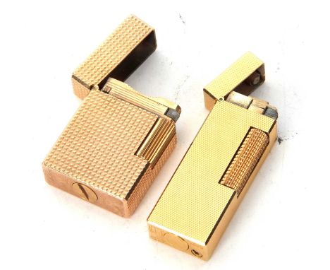 Mixed Lot: A Dunhill roller gas lighter, reference number RE24163 together with a St Dupont, Paris lighter reference DD4073 (