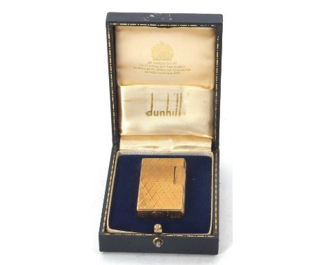 A vintage gold plated Dunhill 70 lighter in original fitted folding case