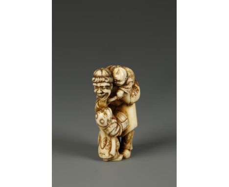 A JAPANESE IVORY FIGURE GROUP NETSUKE attributed to Hidemasa, showing a man and two boys playing, unsigned, circa 1830, 2" hi