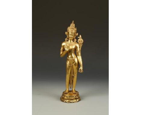 A SINO-TIBETAN LARGE GILT-BRONZE BODHISATTVA standing upright with one hand raised, the other holding a flower, standing on a