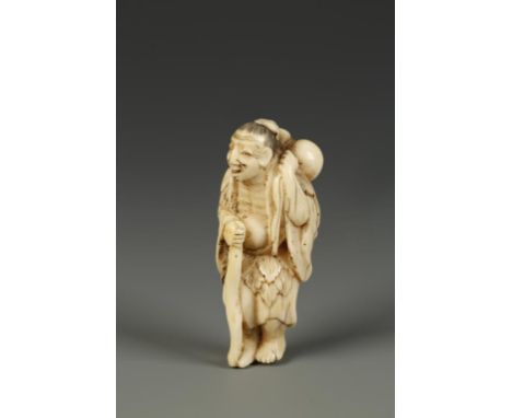 A JAPANESE IVORY NETSUKE OF A SENNIN, the figure holding a staff and with a gourd sack draped over one shoulder, circa 1850, 