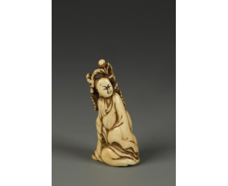 A JAPANESE STAG ANTLER SAGE NETSUKE, the figure reclining on rocks beside chrysanthemum, circa 1850, 2" high