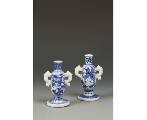 TWO SIMILAR CHINESE BLUE AND WHITE MINIATURE VASES of rounded form with serpent handles, one decorated with dragons, the othe