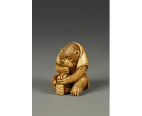 A JAPANESE IVORY MONKEY NETSUKE, the seated animal holding a magnifying glass, signed Masamitsu, circa 1900, 1.5" high