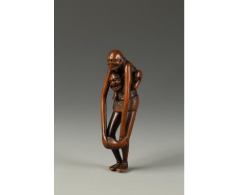 A JAPANESE WOOD ASHINAGA AND TENAGA NETSUKE showing Ashinaga with Tenaga on his shoulders, the latter holding a fish, unsigne