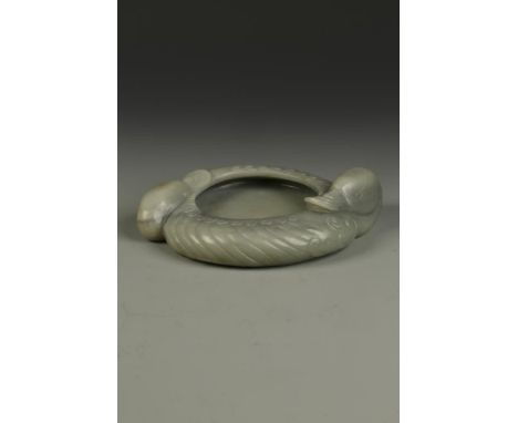 A LARGE CHINESE JADE 'TWO DUCKS' WASHER of circular form, the two birds conjoined and facing in opposite directions, the exte