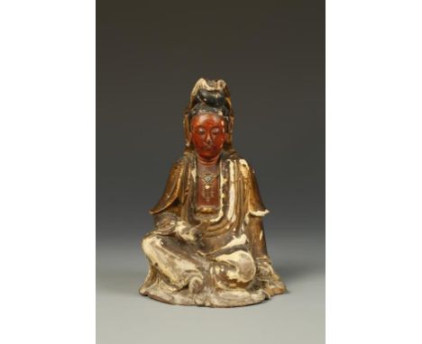 A CHINESE GILTWOOD AND GESSO FIGURE OF GUANYIN, the deity seated at her ease and holding a scroll, Qing, 7.25" high