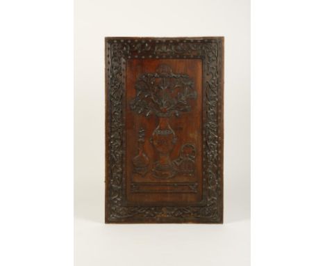 A LARGE PAIR OF CHINESE CARVED WOOD PANELS, each decorated with a central vase of flowers within a foliate scroll border, Qin