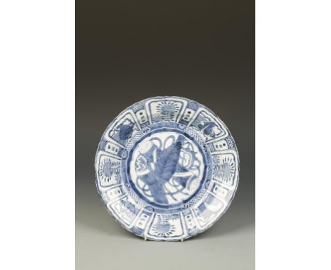 A CHINESE BLUE AND WHITE 'KRAAK' DISH, the centre decorated with a leaf and scroll, within an ogee panelled border, Wanli, 12