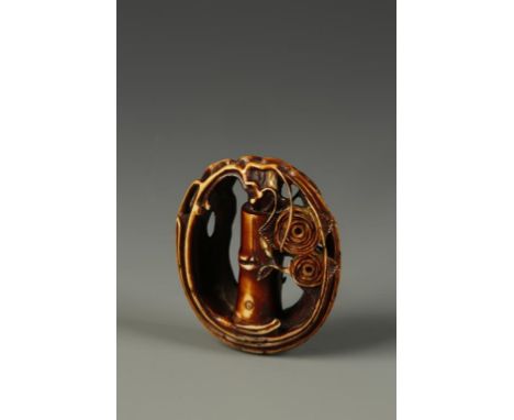 A JAPANESE STAINED IVORY NETSUKE OF A HANA-IKE by Shuosai, carved in the round, signed on one side, circa 1880, 1.75" long