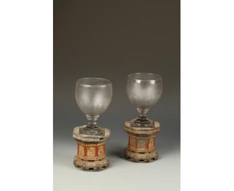 AN UNUSUAL PAIR OF CHINESE PARCEL-GILT OCTAGONAL STANDS, and associated English glass rummers, the stands with open-work pane