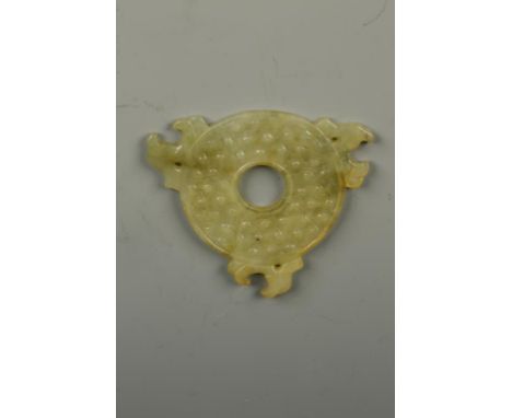 A SMALL CHINESE JADE BI DISC carved in low-relief on each side with archaic scrolls and nodules, the rim with three stylised 