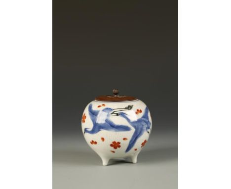 A JAPANESE OVOID TRIPOD VESSEL BY MAKUZU KOZAN (1842-1916), decorated in underglaze blue, iron red and black showing cranes i