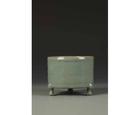 A CHINESE RU STYLE TRIPOD VESSEL of cylindrical form with horizontal banded decoration, the finely crackled glaze of a greeni