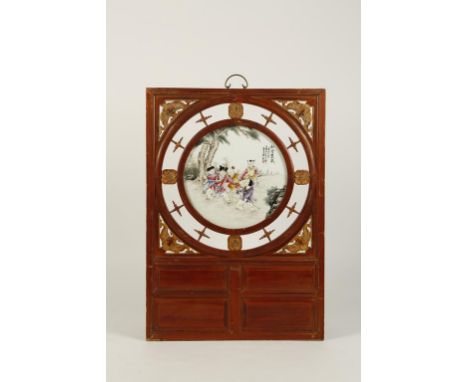 A CHINESE PORCELAIN-MOUNTED PARCEL-GILT PANEL, the upper section with a central famille-rose roundel showing children playing