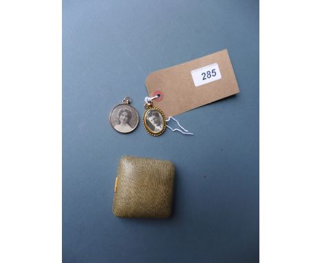 A collection of three yellow metal portrait lockets 