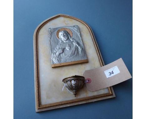 A marble backed icon, the cast metal portrait of Jesus signed L. DE Helly 