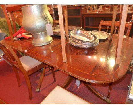 A Regency style mahogany and line inlaid twin pillar dining table 