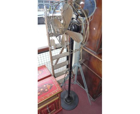 A vintage floor standing fan, black painted the badge bearing the letters W & S