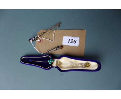 A cased citrine tie pin, gold mounted and similar 