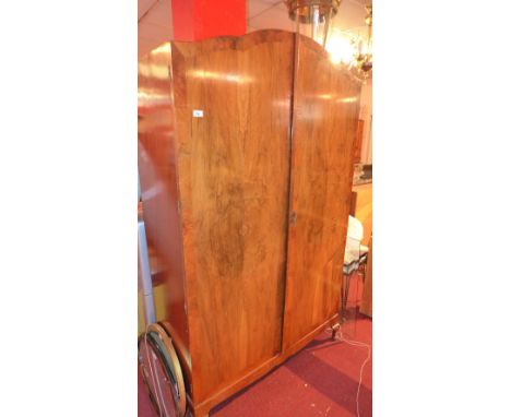 A wardrobe with panel doors and mirror interior on base 