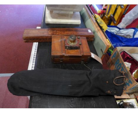 A vintage camera and tripod and cigar press