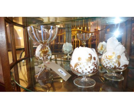 An Italian hand blown glass cup of ornate design with gilt detail (a/f) together with three brandy balloons with gilt figures