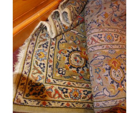 A large Persian carpet with floral designs on an olive field surrounded by a frieze and running borders 375 x 258cm 