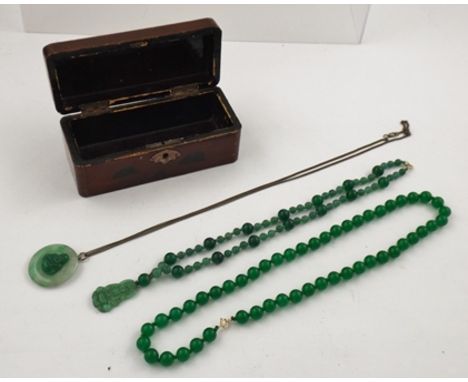 TWO JADEITE NECKLETS of uniform row with gold coloured metal clasp, 58cm long, ANOTHER with Guan Yin pendant, 50cm long, and 