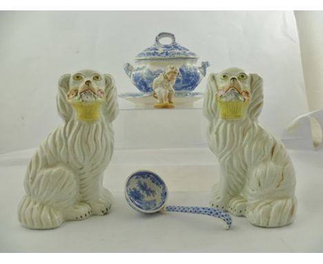 A PAIR OF 19TH CENTURY STAFFORDSHIRE POTTERY MANTEL DOGS, moulded with baskets of flowers in their mouths, polychrome painted