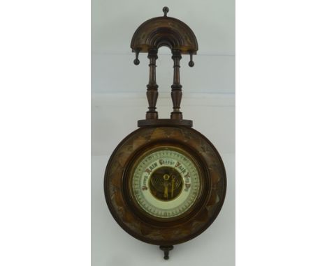 AN EDWARDIAN STAINED WOOD CASED WALL BAROMETER in decorative case, 41cm overall 