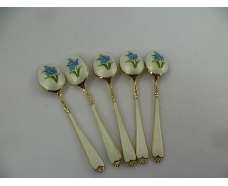 A 20TH CENTURY SUITE OF FIVE FOREIGN SILVER COLOURED METAL AND ENAMEL, SILVER GILT COFFEE SPOONS with floral decorated bowls,