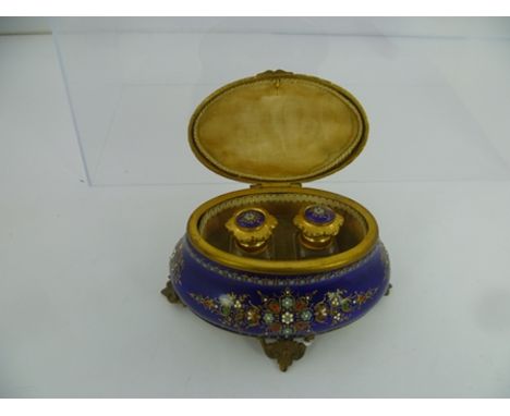 A 20TH CENTURY OVAL BASE METAL AND ENAMEL TRINKET BOX decorated in blue enamel with turquoise, red and green, 8cm high x 14.5