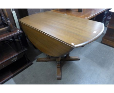 An Ercol Golden Dawn elm and beech drop-leaf table 