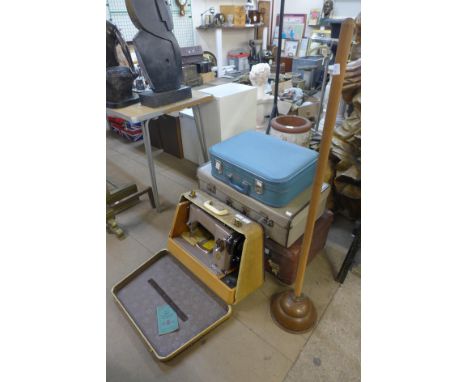Three vintage suitcases and a Singer sewing machine, etc. 