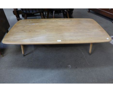 An Ercol Blonde elm coffee table, on associated legs 