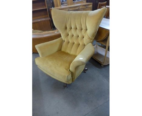 A G-Plan Blofeld teak and yellow fabric revolving lounge chair, model 6250, designed by Paul Conti 