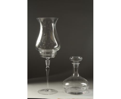 A TALL PLAIN CLASS STORM LAMP ON STAND. 18ins high and a plain ships decanter and stopper.