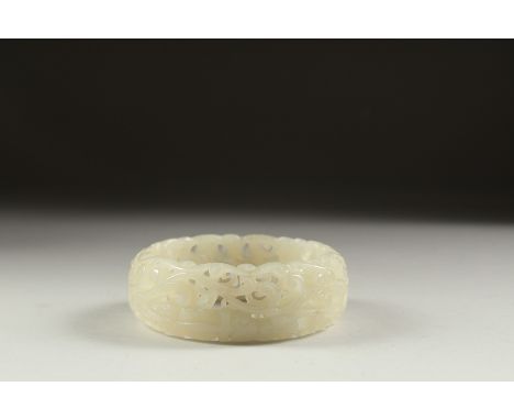 A CHINESE WHITE JADE BANGLE. 3ins diameter.