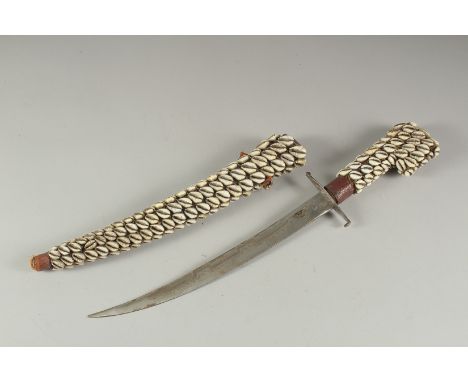 A COWIE SHELL COVERED DAGGER AND SHEATH. 19ins long.