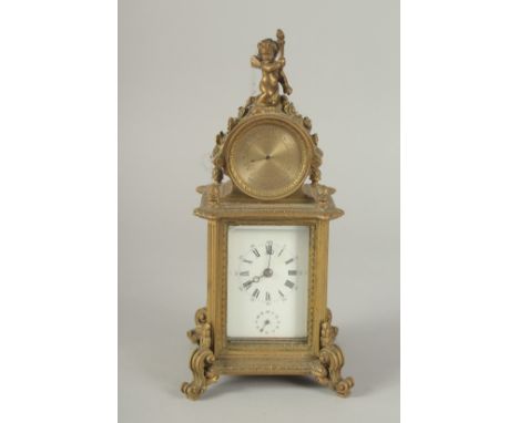 A 19TH CENTURY FRENCH BRASS CLOCK surrounded by a barometer 8ins high.