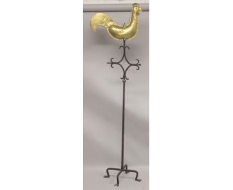 A COCKERAL BRASS WEATHER VANE on a early iron stand.