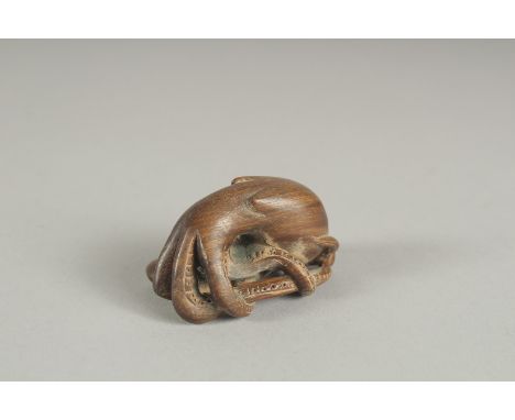A HARDWOOD OCTOPUS NETSUKE.